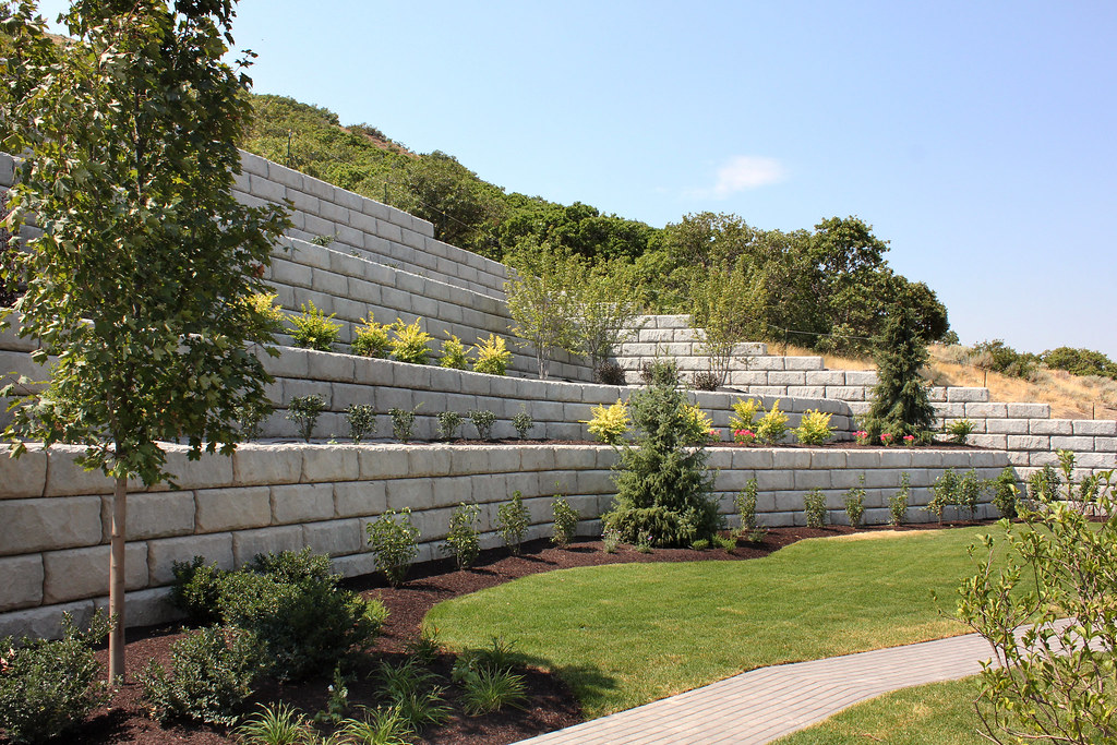 Tiered limestone retaining wall with layered garden planting